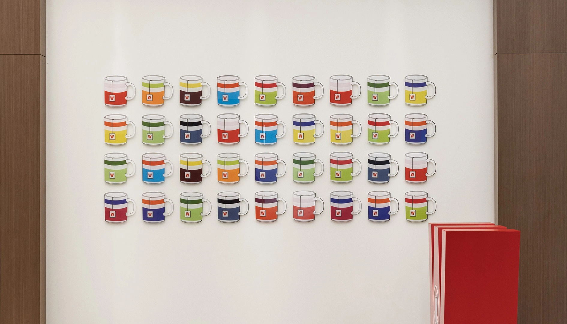 Custom 3D painted acrylic mug wall installation for Wissotzky office spatial design.