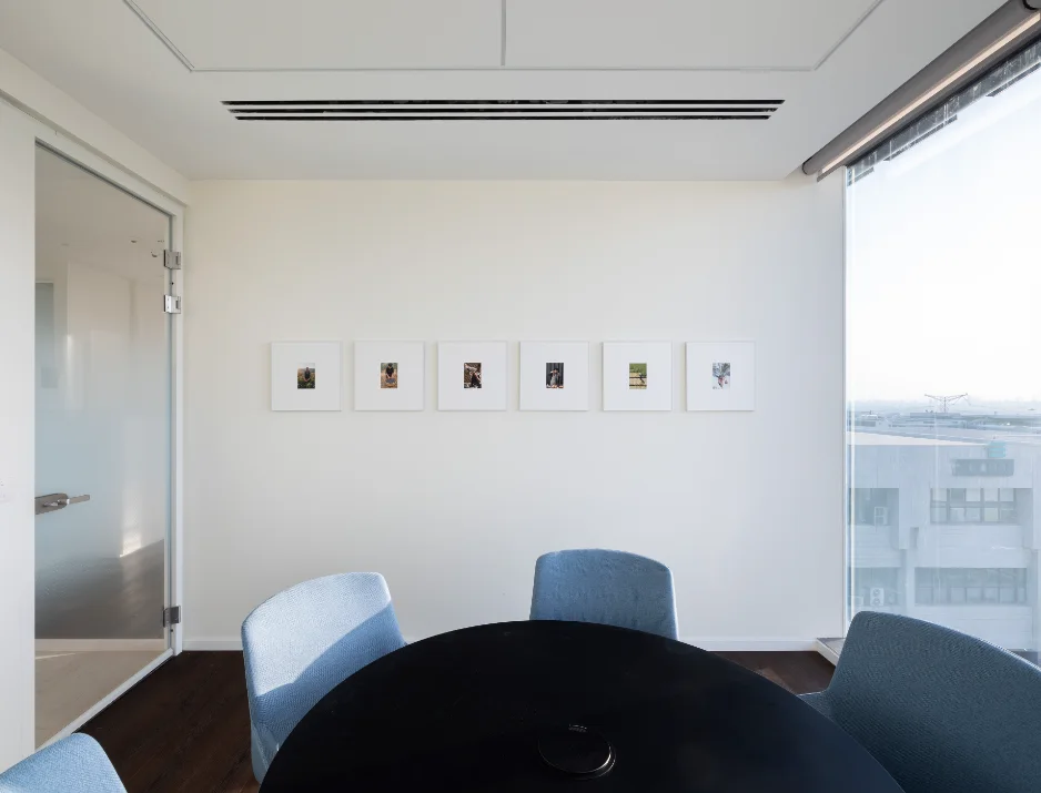 Environmental graphic design featuring custom framed photography and brand storytelling wall display.