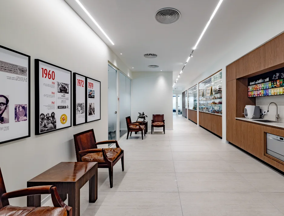 Corporate history timeline display featuring custom framed wall prints in office corridor