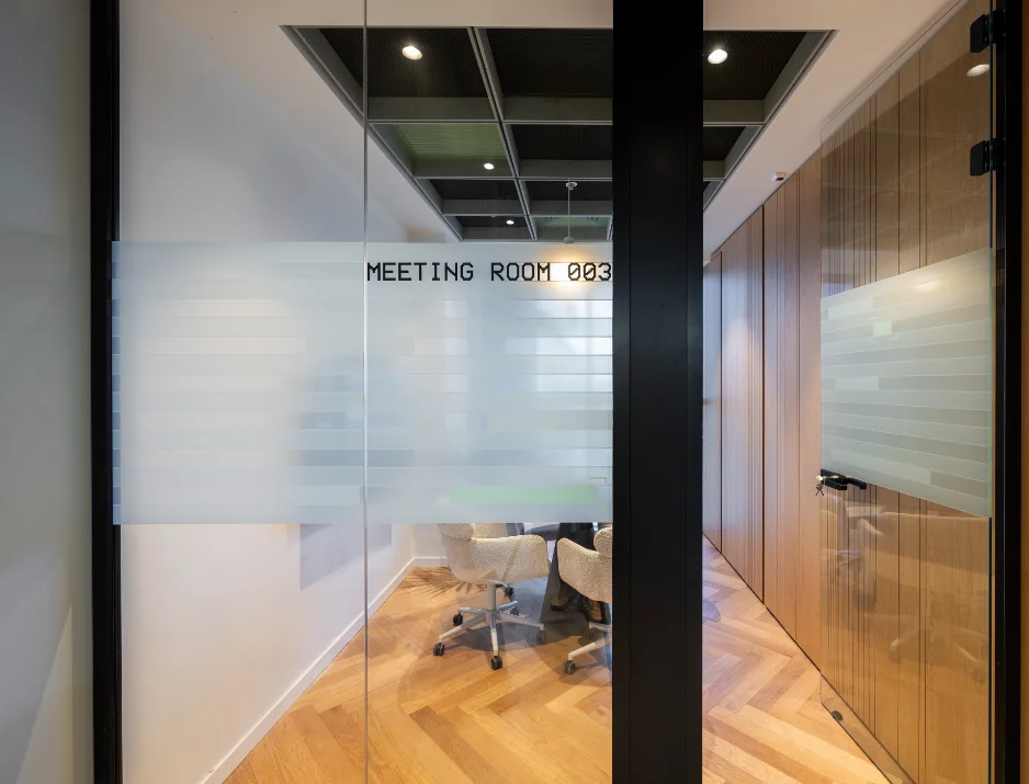 Patterned frosted glass privacy film with cut vinyl meeting room office signage